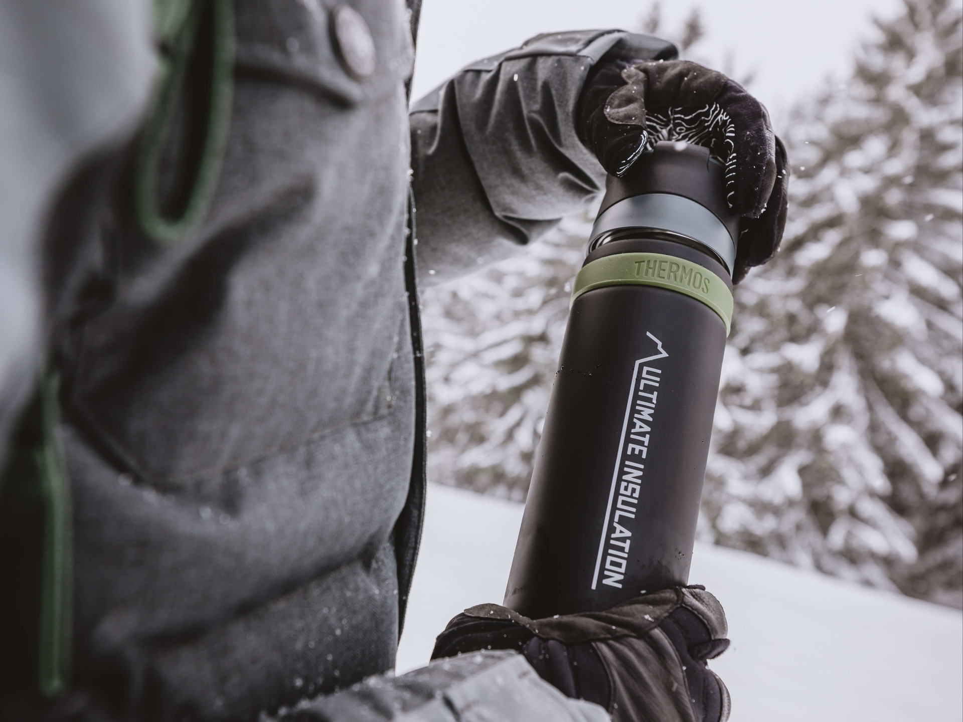 Thermos with a hot drink on mountain waterfall Stock Photo by